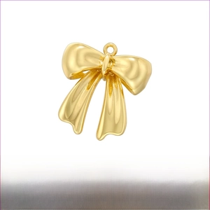 Detailed view of gold brass bow pendant with dimensions 18.5mm by 20mm and weight 3g