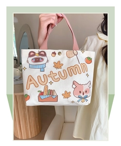 Detail of canvas tote bag showing Autumn raccoon print and pink fabric handles