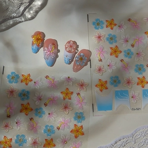 Close-up of 3D embossed floral nail stickers with gradient blue and pink flower petals