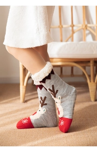 Detail of Christmas reindeer socks with warm fleece lining and snowflake pattern