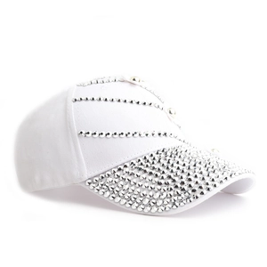 Close-up of sparkling silver rhinestones and flower applique on white baseball cap