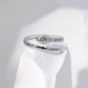 Detailed macro shot of silver snake ring with scales texture and adjustable open band
