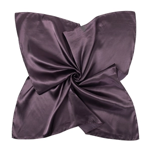 Detail shot of a deep purple satin silk square scarf with elegant spiral folding texture