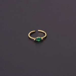 Adjustable gold open ring featuring a green marquise-cut stone with beaded metal texture