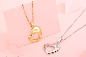 Detail of gold and silver heart-shaped hollow pendants with tiny embedded diamonds