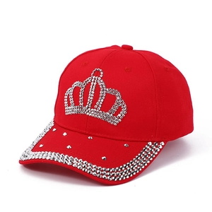 Detail of red denim baseball cap with silver rhinestone crown pattern and brim edge