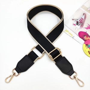 Adjustable black and yellow canvas strap with gold metal buckle and leather ends