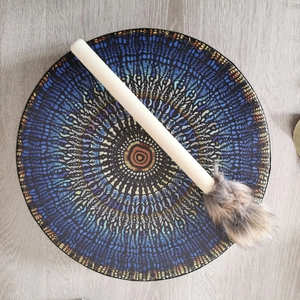 Top view of handmade drum with blue mandala patterns and fur-trimmed wooden mallet