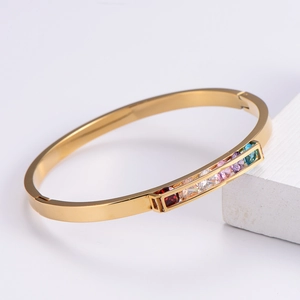 Elegant gold-plated open bangle featuring a row of vibrant multi-colored rectangular gemstones