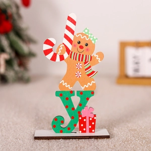 Detail of wooden Christmas Joy sign with gingerbread man and red gift box desktop decor