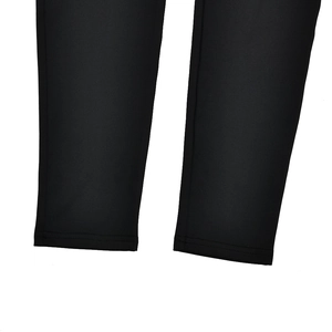 Close-up of the smooth black knit fabric texture and hem stitching on these bodysuit legs