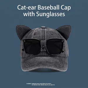 Detail of grey denim baseball cap featuring 3D cat ears and integrated black sunglasses