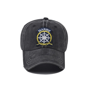 Detailed close-up of Marine embroidery and distressed details on a washed cotton baseball cap