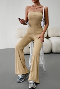 Detail of beige ribbed strapless jumpsuit fabric texture and elegant slim fit style