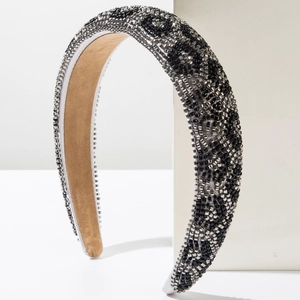 Close-up of handmade beadwork headband featuring leopard pattern in black and silver