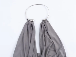 Detailed close-up of dark grey halter top with elegant silver metal collar ring