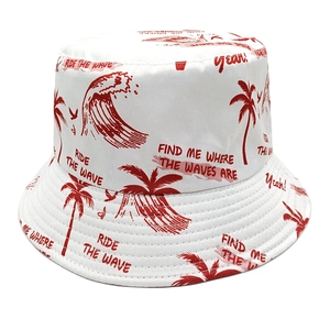 White reversible bucket hat with red coconut palm tree and ocean wave patterns