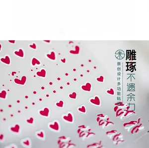 Macro view of ultra-thin red heart nail decals and polka dot patterns on clear film