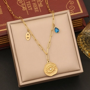 Golden paperclip chain necklace with evil eye coins and blue droplet pendant