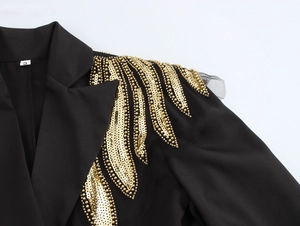 Close-up of black blazer shoulder featuring intricate gold sequins and beadwork, size S
