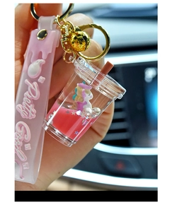 Close-up of pink liquid unicorn glitter keychain with silicone wristlet and golden bell