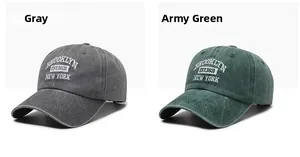 Detail of embroidered vintage Brooklyn lettering on gray and olive green cotton baseball caps