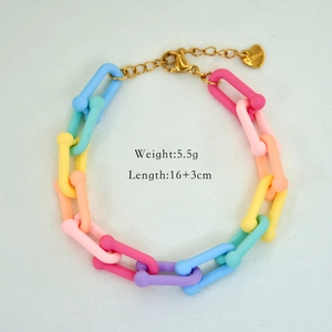 Detail of colorful acrylic link bracelet with gold lobster clasp and heart tag