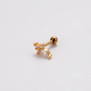Detail of gold cartilage stud featuring marquise and round cubic zirconia with ball back