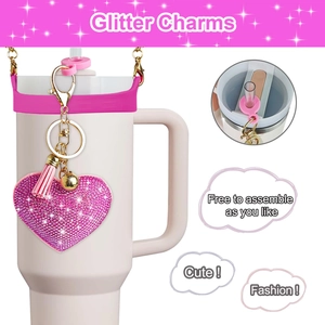 Close-up of pink glitter heart charm with tassel and gold bell for water bottles