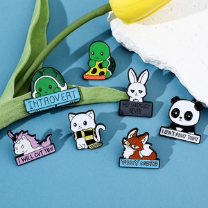 Flat lay of colorful enamel animal brooches with humorous text on blue background