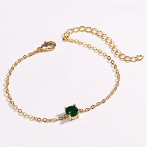 Minimalist gold link bracelet with a round green gemstone and lobster clasp closure