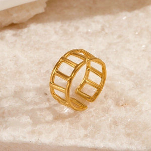 Minimalist 18K gold plated geometric hollow open ring on a textured white stone base