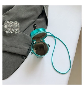 Detail showing the inner fabric lining and zipper closure of the cyan cylinder bag