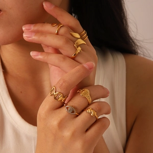 Detail showing vintage gold-plated rings including feather and evil eye designs