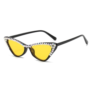 Retro cat-eye sunglasses with black frame, yellow lenses and colorful rhinestone accents
