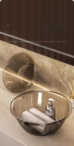 Macro detail of two nested amber translucent washbasins on a luxury stone bathroom vanity