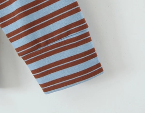 Detail shot of blue and brown striped knit fabric texture with ribbed cuff finish