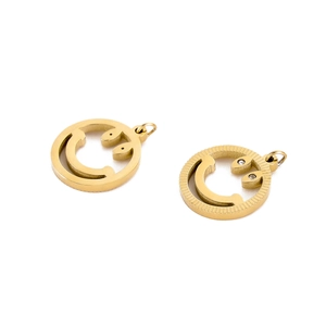 Macro shot of gold hollow smiley face pendants with plain and diamond-encrusted edges