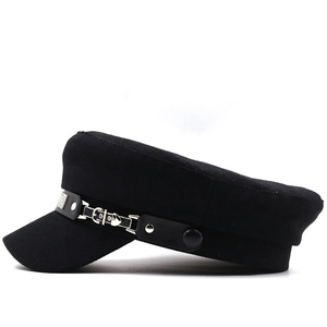 Detail of black baker boy hat featuring silver buckle, studs and rhinestone embellishments