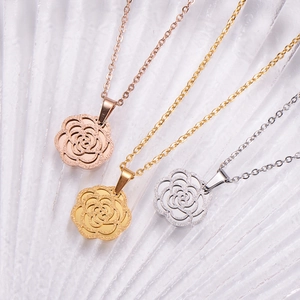 Detailed trio of rose gold, gold and silver frosted flower pendants on cross chains