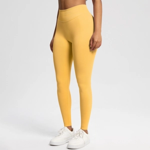 Detail of high waist bright yellow seamless compression leggings for women gym fitness