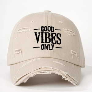 Detail view of khaki distressed baseball cap with Good Vibes Only black embroidery