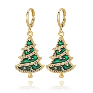 Close-up of golden Christmas tree earrings with green enamel and sparkling zircon stones