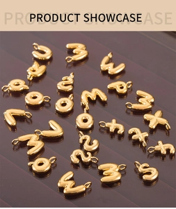 Macro shot of gold bubble alphabet charms with shiny polished finish and ring loops