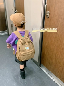 Toddler outdoor backpack in khaki with cloud print shown on a child for size reference