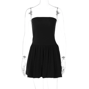 Detail of minimalist black strapless mini dress with cinched waist and pleated A-line skirt