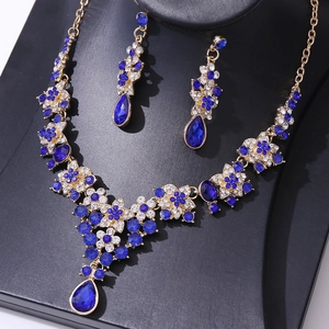 Close-up of luxury bridal necklace set with deep blue pear-cut stones and white crystals