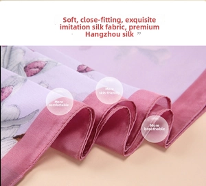 Close-up of printed silk satin scarf with floral patterns showing smooth texture