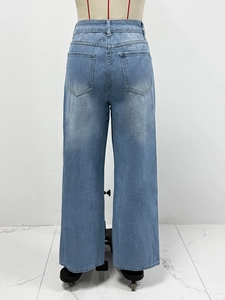 Rear view of high-waisted blue denim wide-leg pants featuring double back pockets on mannequin