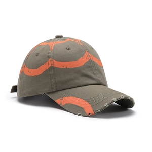 Distressed olive green cotton baseball cap with orange spray-paint style wave patterns